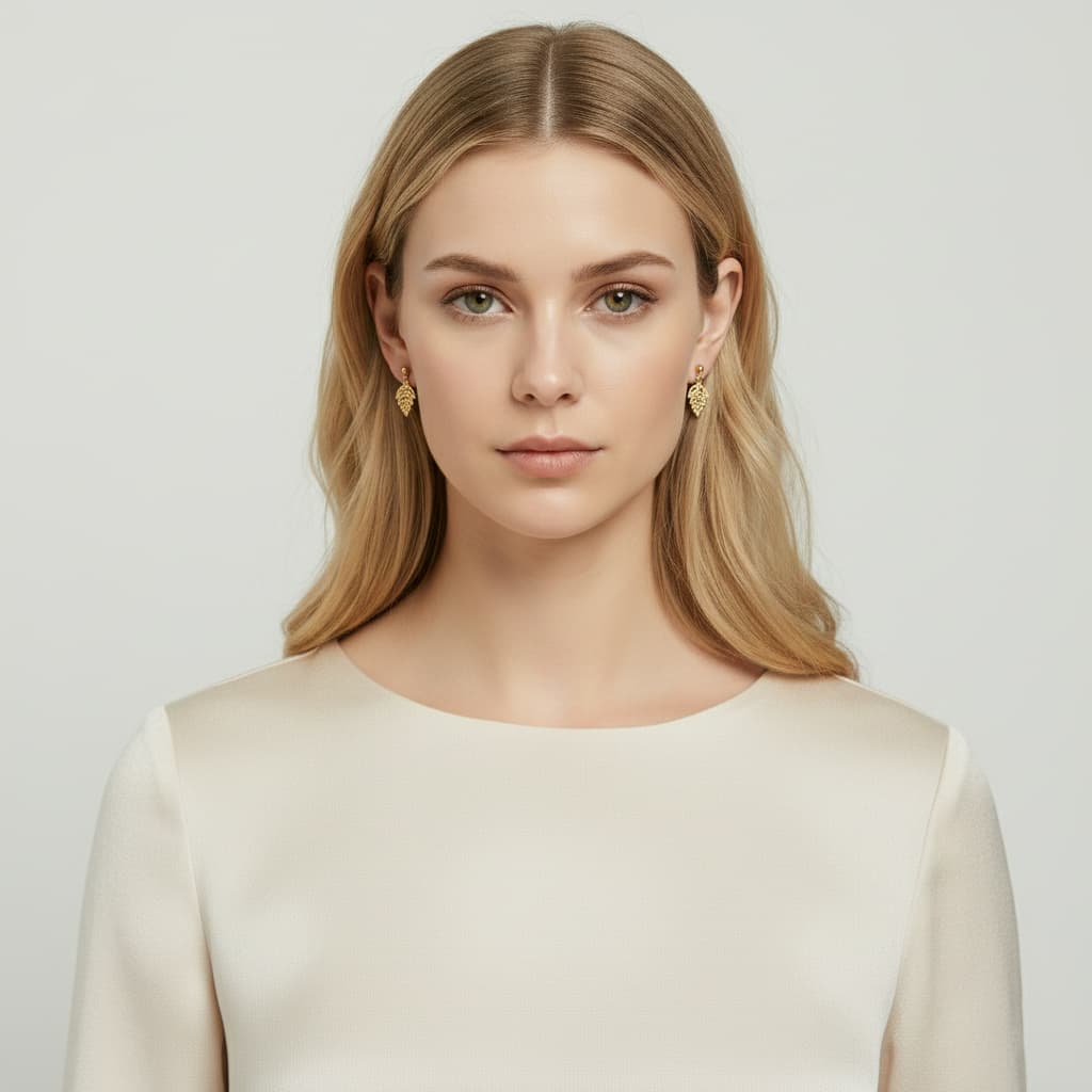 Front view of model wearing 24K gold vermeil leaf earrings.