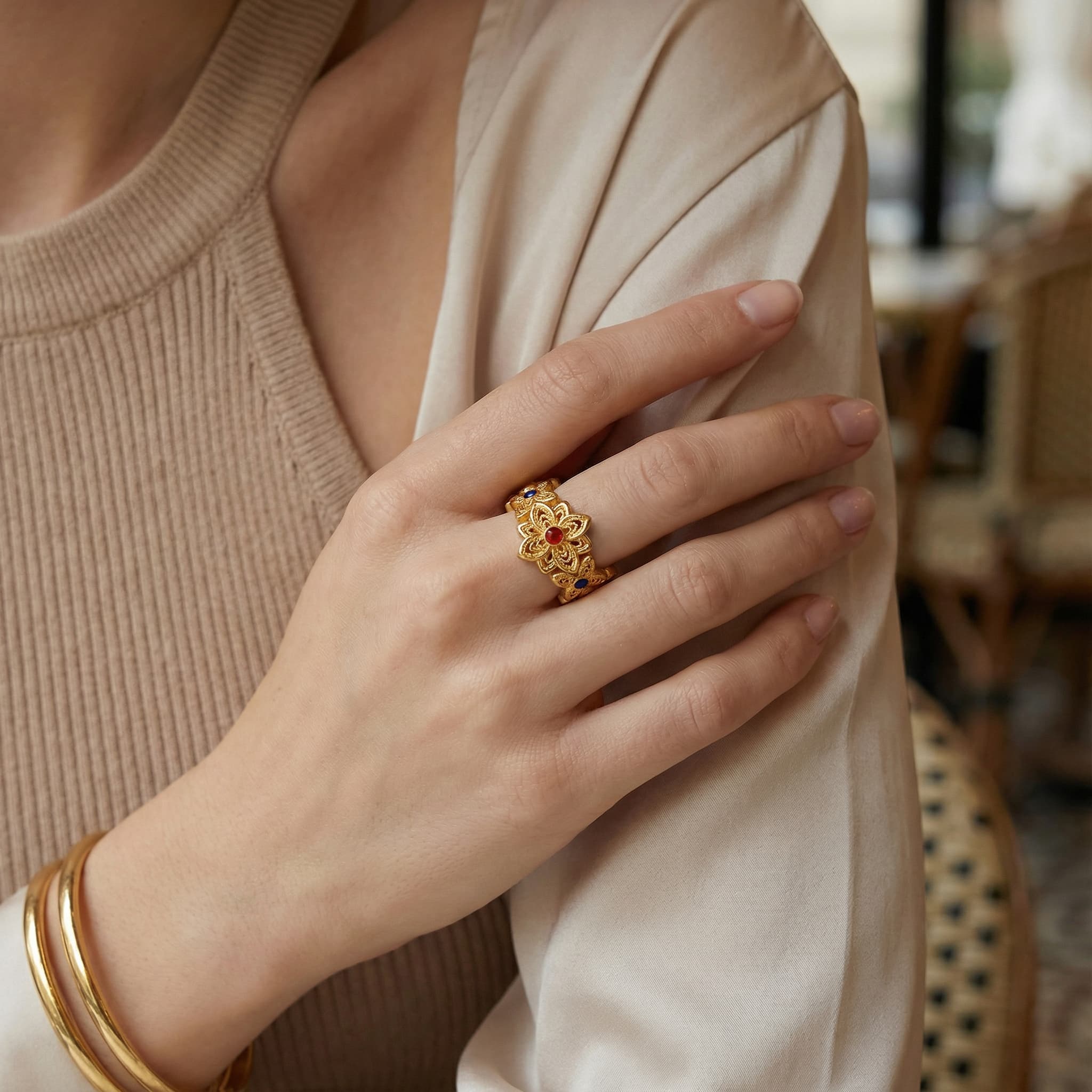 Close up of 24K gold vermeil flower ring on model's hand.