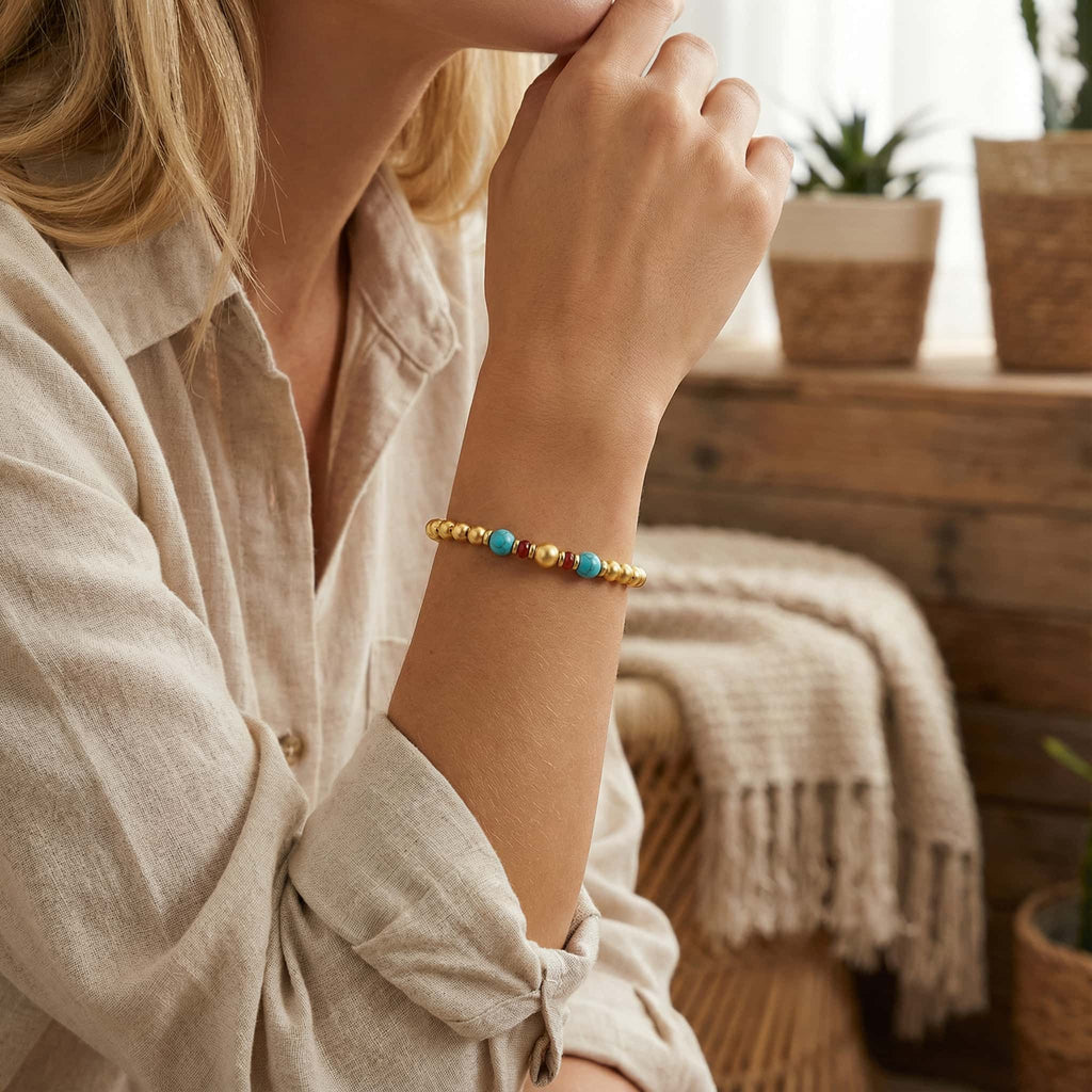[Brand] 24K Gold Plated Turquoise Bead Bracelet worn on wrist, elegant lifestyle shot.